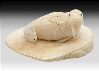 A portly walrus figurine resting on a slice of walrus tusk - Brian Kulik