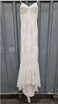 A jaw dropping Ian Stuart wedding dress in a UK size with profuse lace overlay, train and pearl and sequin applique. In fantastic condition. Very expensive similar examples on the designers website - Ian Stuart