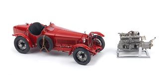 A red vintage car model and a silver engine model displayed on a white background.