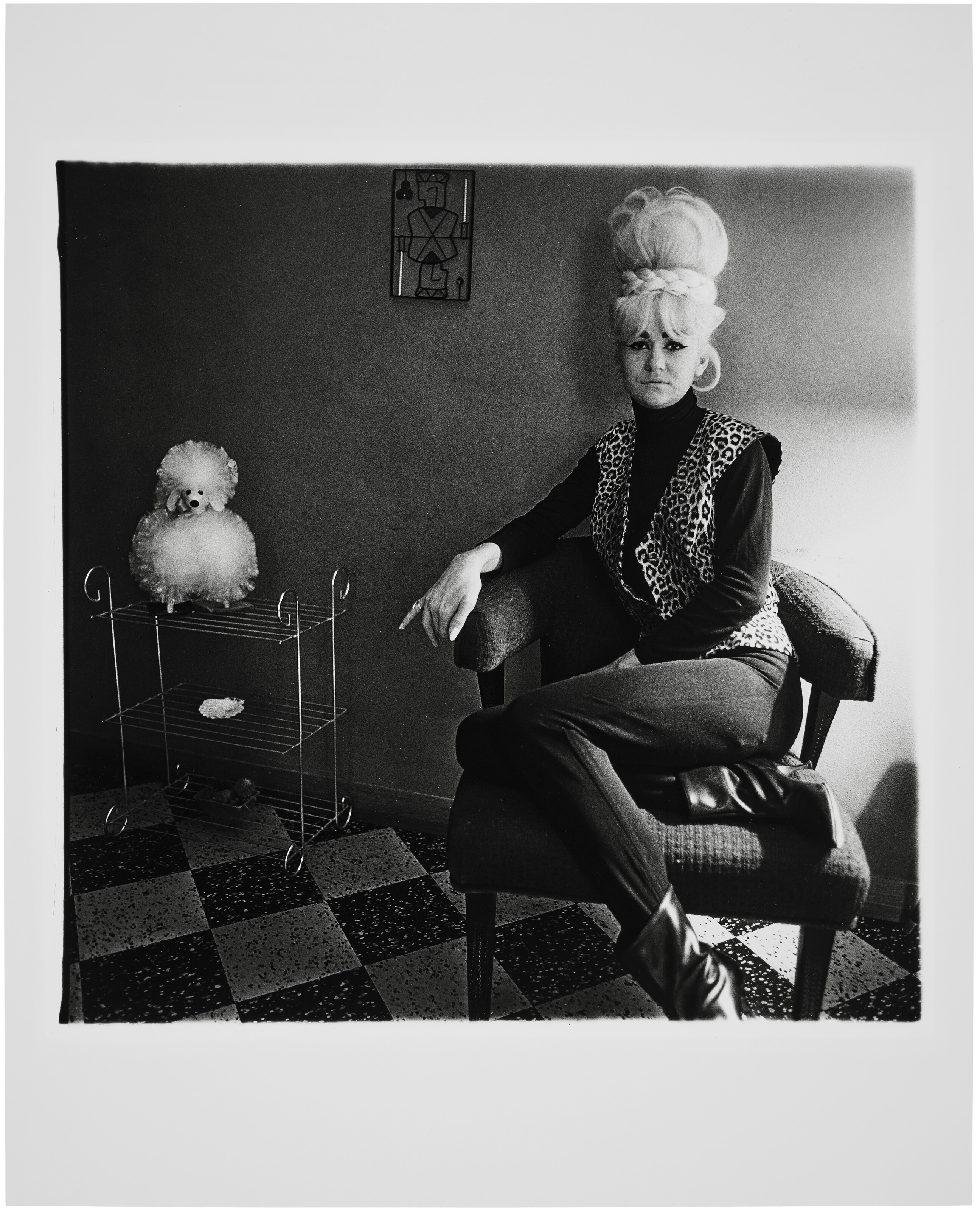 Artwork by Diane Arbus, Lady bartender at home with a souvenir dog, New Orleans, LA., 1964, Made of gelatin silver print