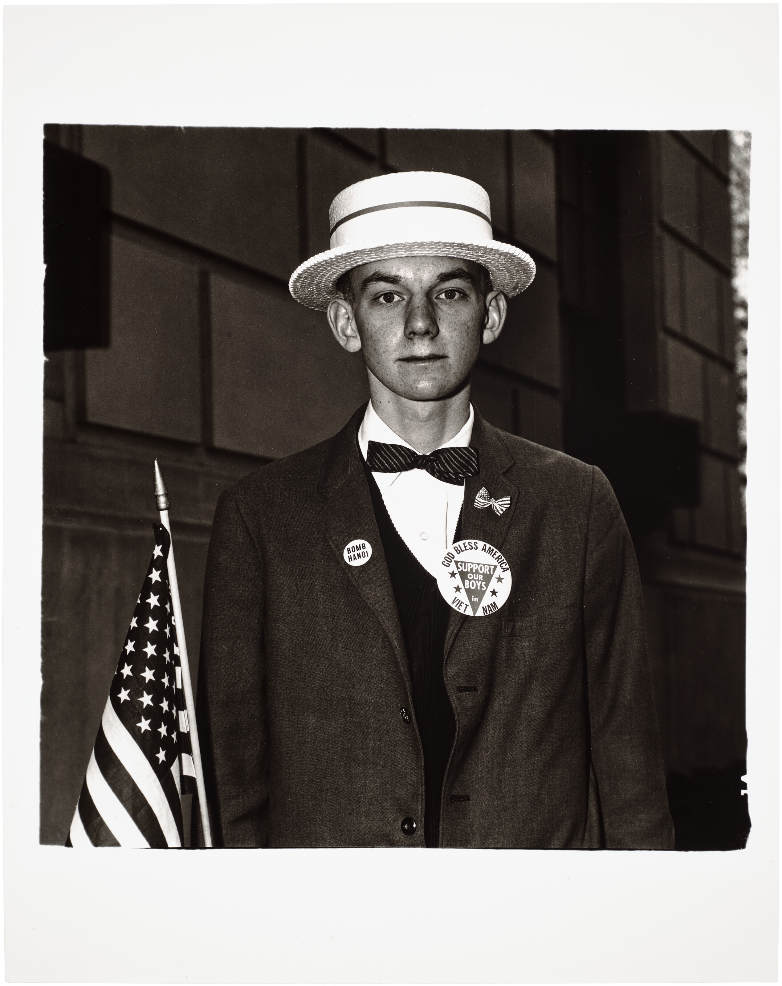 Artwork by Diane Arbus, Boy with a straw hat waiting to march in a pro-war parade, NYC, 1967, Made of gelatin silver print