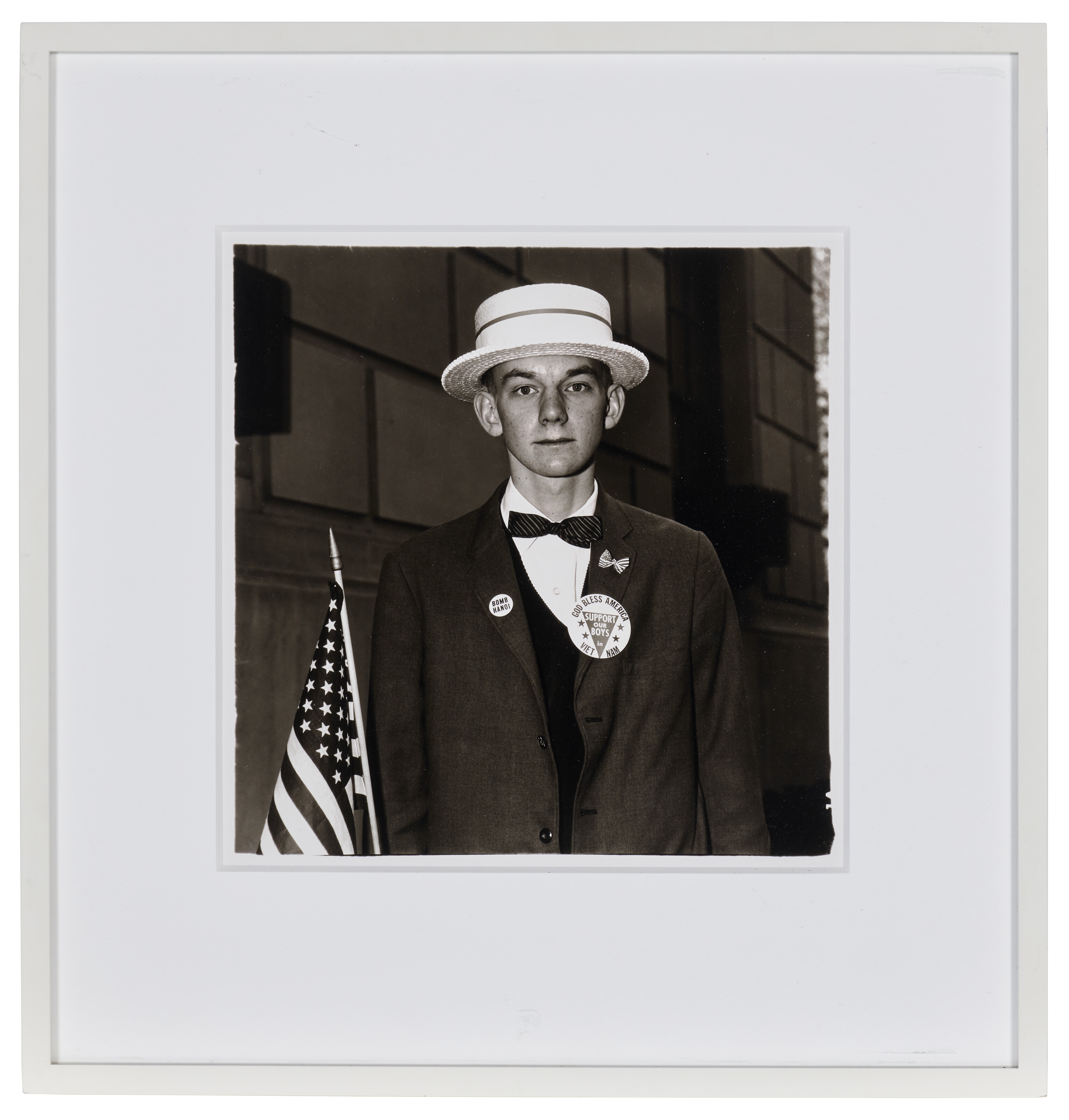 Artwork by Diane Arbus, Boy with a straw hat waiting to march in a pro-war parade, NYC, 1967, Made of gelatin silver print