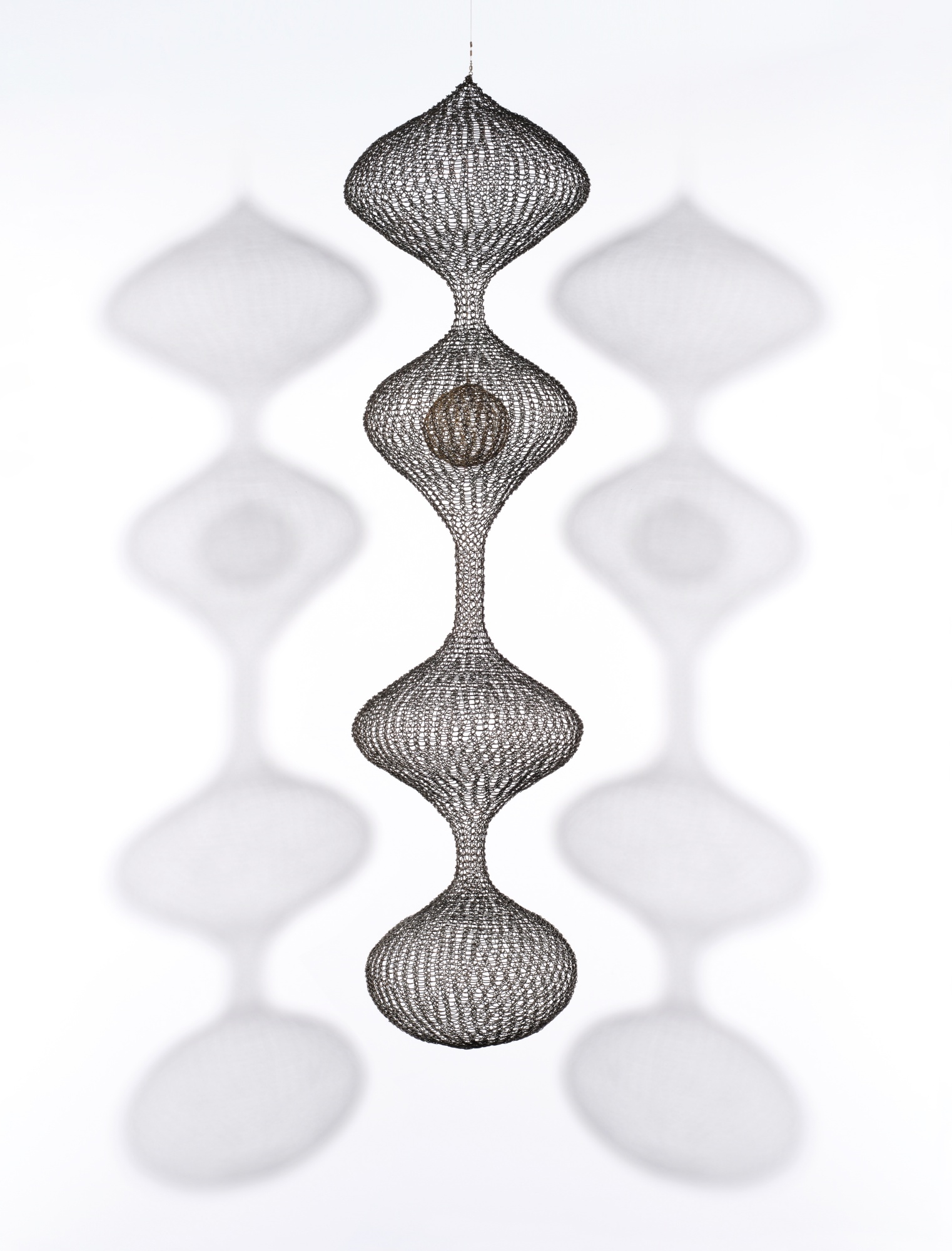 Artwork by Ruth Asawa, Untitled (S.467, Hanging Four-Lobed Continuous Form with a Sphere in the Second Lobe), Made of oxidized copper and brass wire