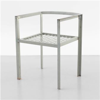 A minimalist chair with a metal frame and textured glass seat.