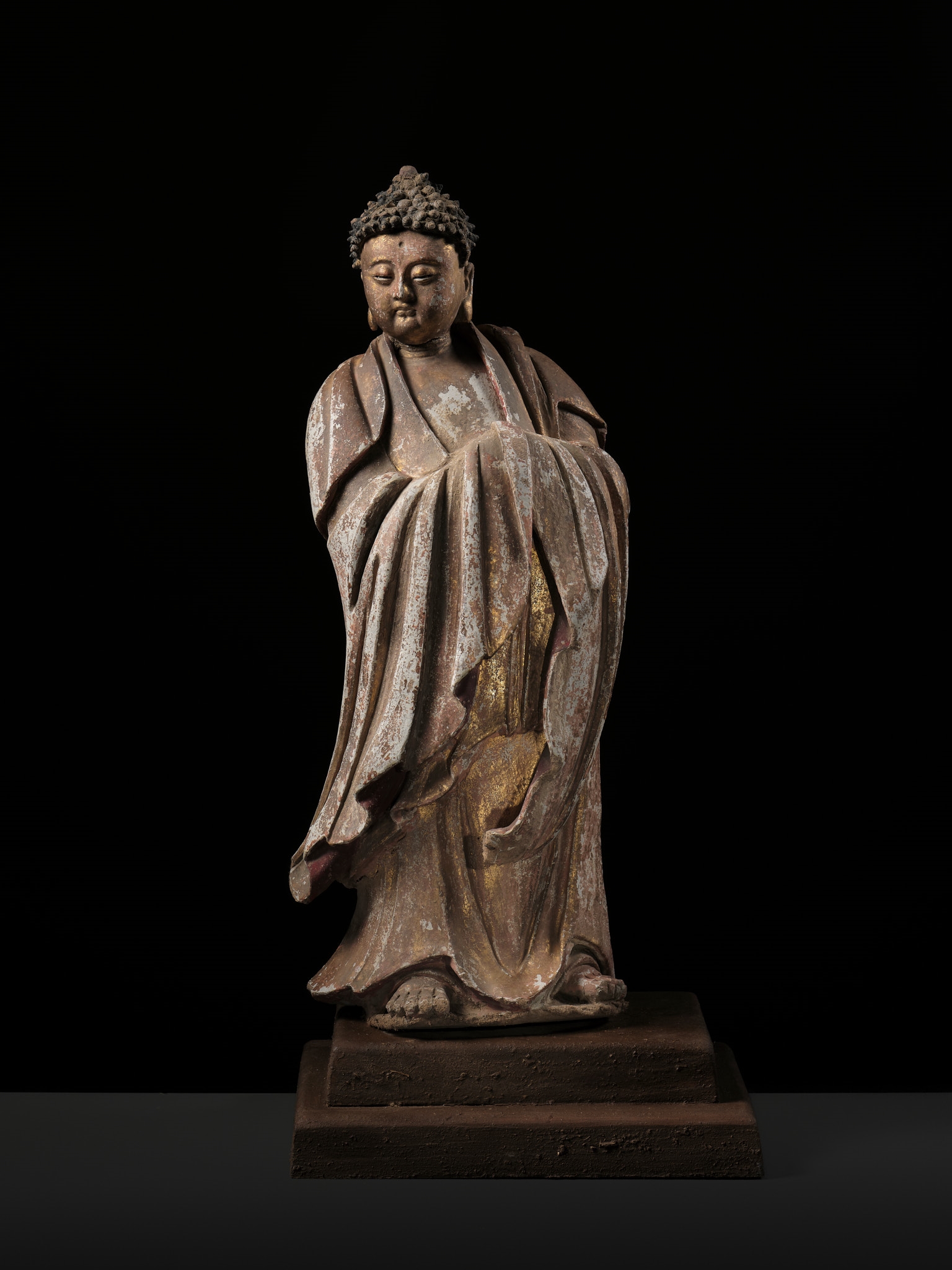 Chinese School | A PAINTED AND GILT STUCCO TEMPLE FIGURE OF A ...