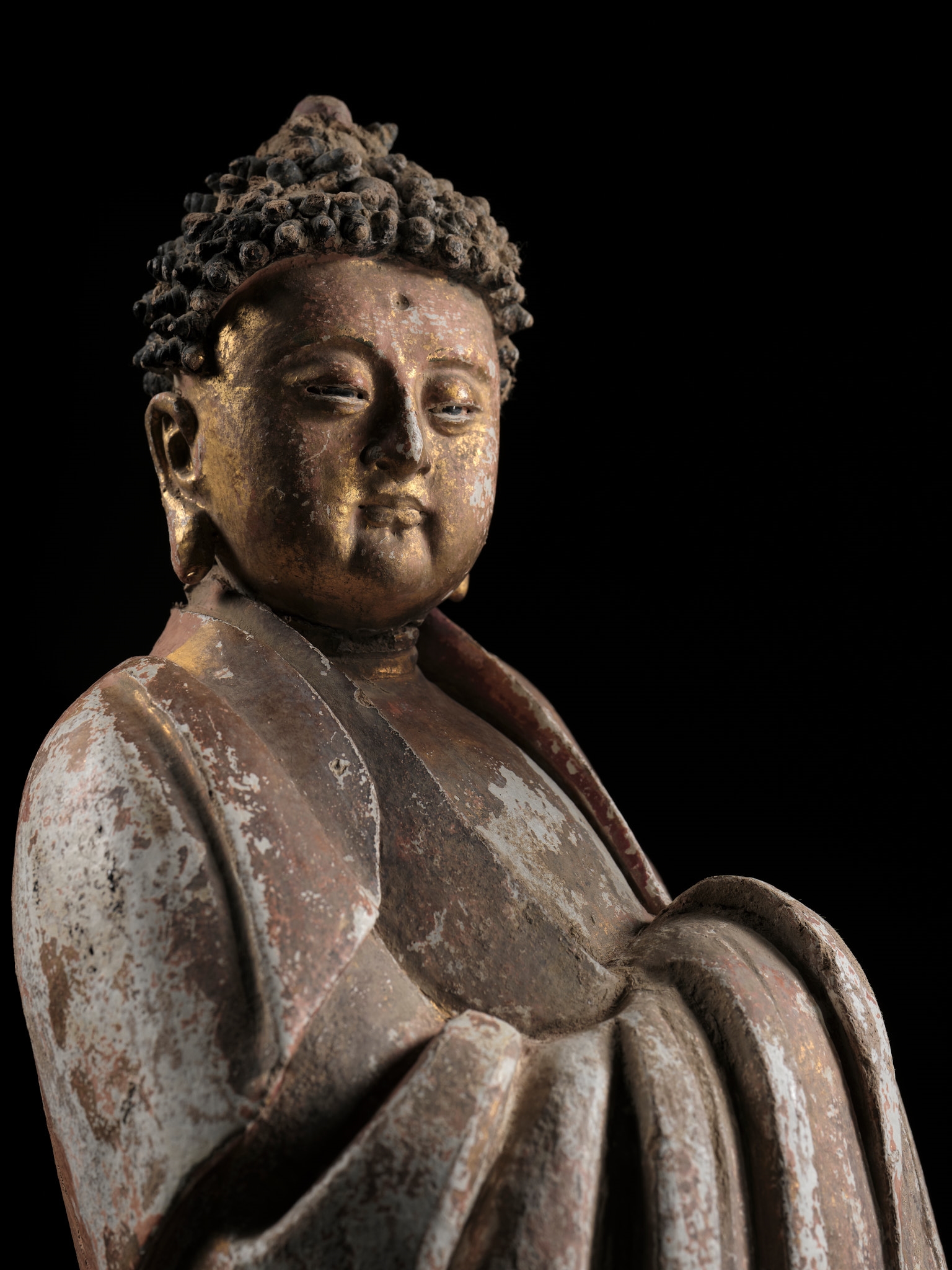 Chinese School | A PAINTED AND GILT STUCCO TEMPLE FIGURE OF A ...