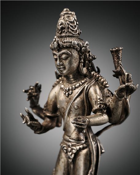 A SILVER FIGURE OF SIX-ARMED LOKESHVARA, CENTRAL JAVA, 9TH