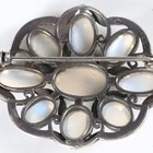 Artwork by Sybil Dunlop, An early 20th century Arts and Crafts silver and moonstone set brooch by Sybil Dunlop, Made of shaped oval