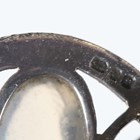 Artwork by Sybil Dunlop, An early 20th century Arts and Crafts silver and moonstone set brooch by Sybil Dunlop, Made of shaped oval