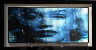 A digital portrait of a face rendered in cascading blue binary code.