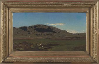 A framed landscape painting depicting a mountainous valley with a small settlement under a blue sky.