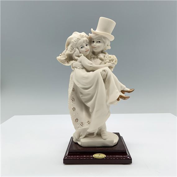 Fine crafted resin with white matte finish captures a young couple celebrating their recent marriage