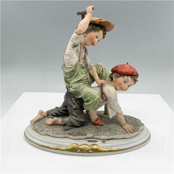 Fine crafted resin captures two young boys playing
