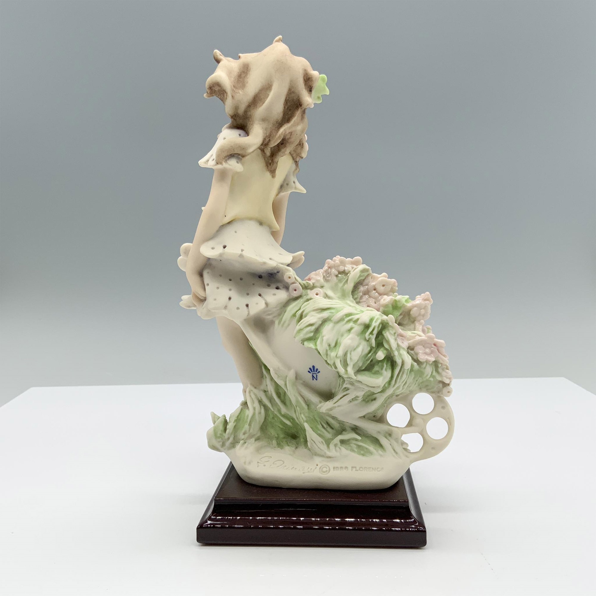 Artwork by Giuseppe Armani, Fine crafted resin with white matte finish captures a young girl carrying a cart full of flowers, Made of resin with white matte