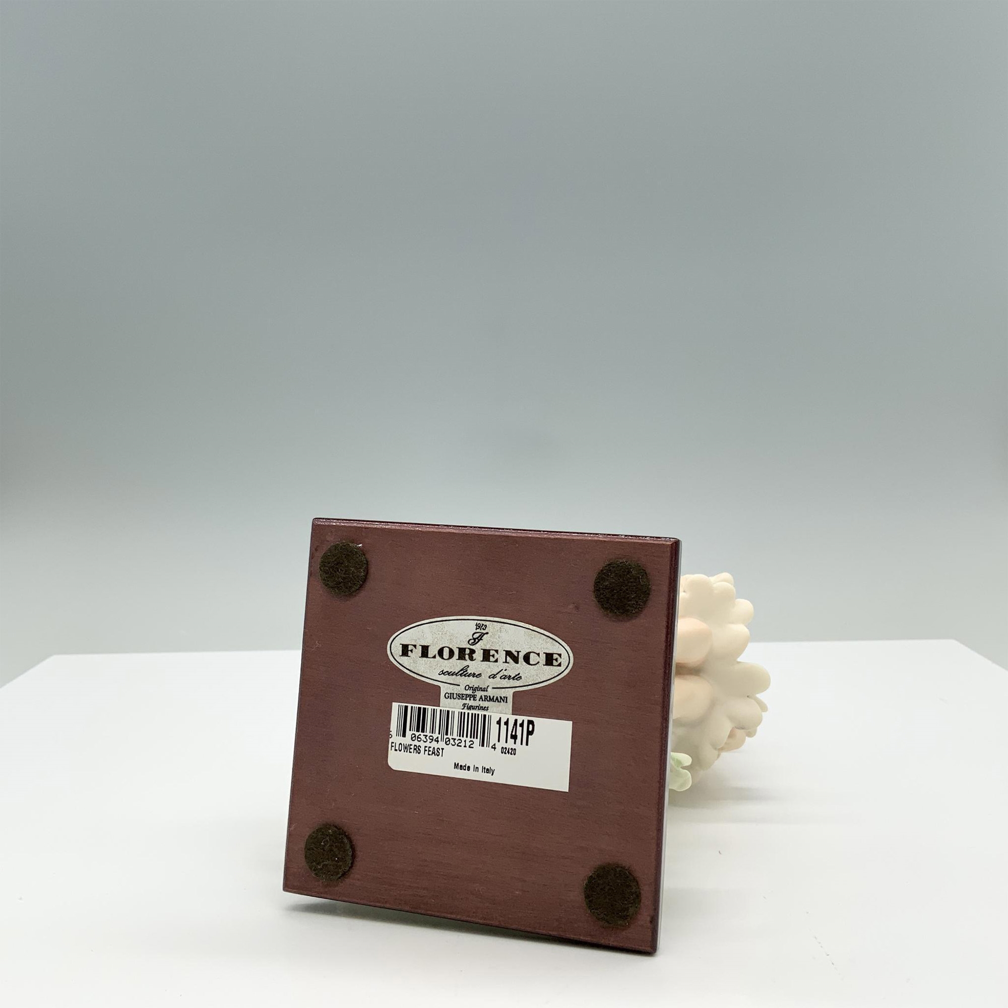 Artwork by Giuseppe Armani, Fine crafted resin with white matte finish captures a young girl carrying a cart full of flowers, Made of resin with white matte