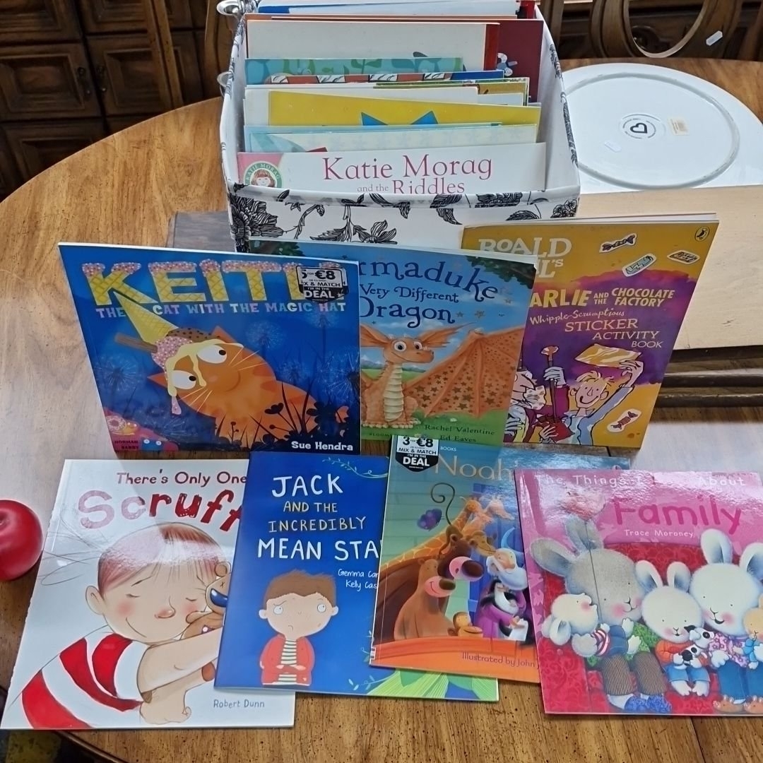 Artwork by Peter Donnelly, Collection of books including titles like "The President's es" by Peter Donnelly, and "Charlie and the Chocolate Factory" activity book, Made of Glass