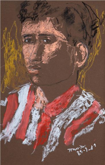 Jeune homme portant un maillot de l'Olympiakos