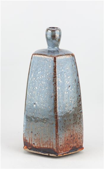 JAMES HAKE (born 1979); a tall faceted stoneware bottle covered in shino and cobalt glaze by James Hake
