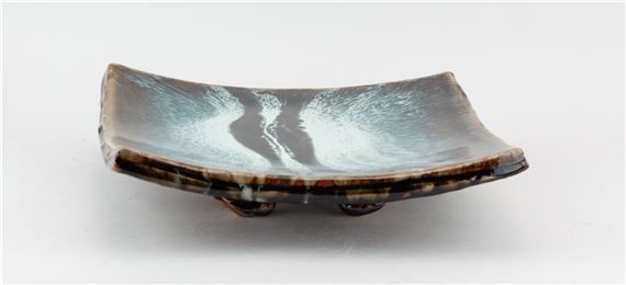 JAMES HAKE (born 1979); a square stoneware footed dish partially covered in streaky nuka glaze with tenmoku pours by James Hake