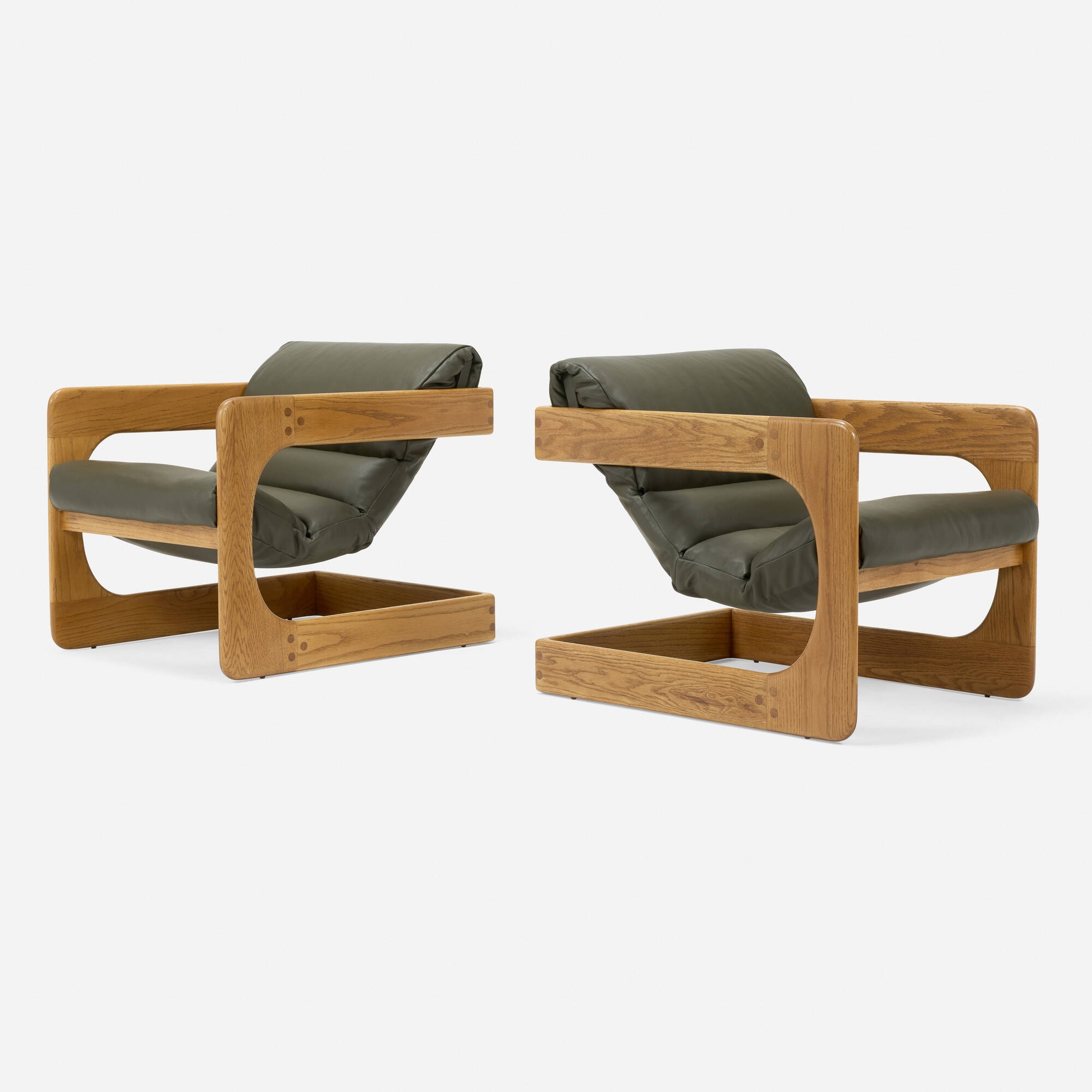 Artwork by Lou Hodges, Lounge chairs, pair, Made of oak, leather