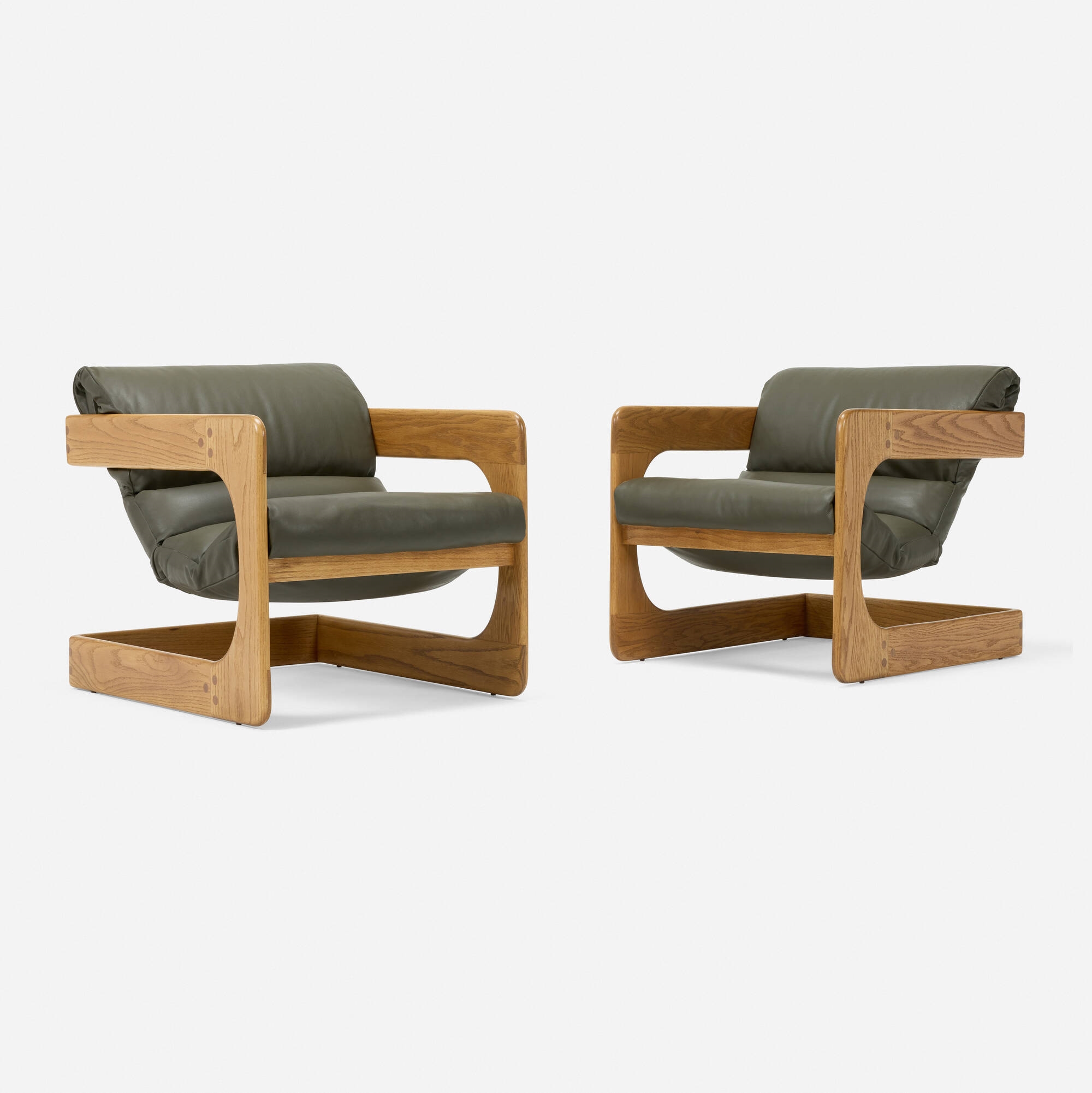 Artwork by Lou Hodges, Lounge chairs, pair, Made of oak, leather