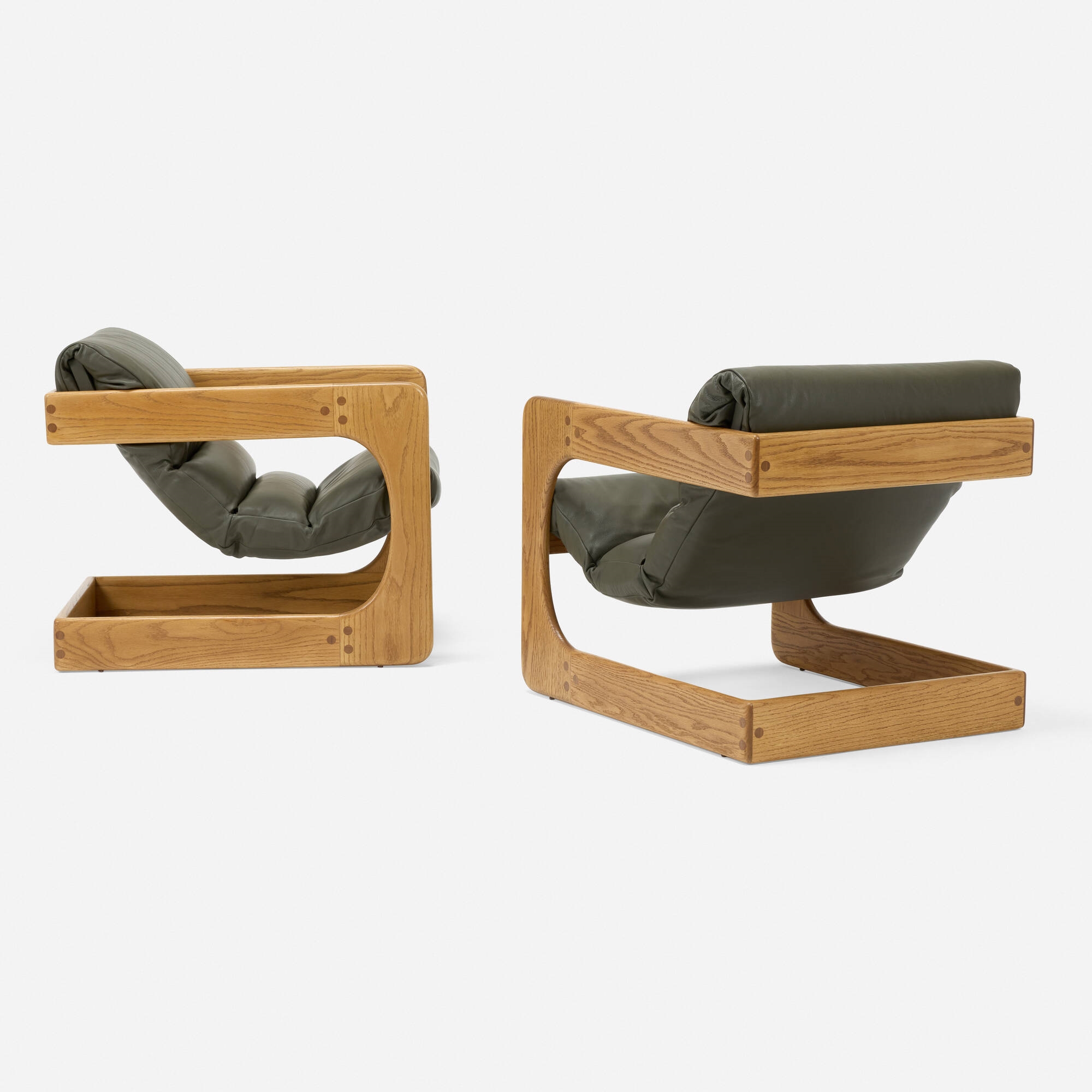 Artwork by Lou Hodges, Lounge chairs, pair, Made of oak, leather