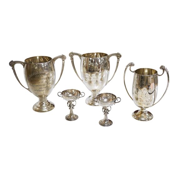 Five assorted small silver trophy cups including a pair by Edward Barnard & Sons by Edward Barnard, 1936
