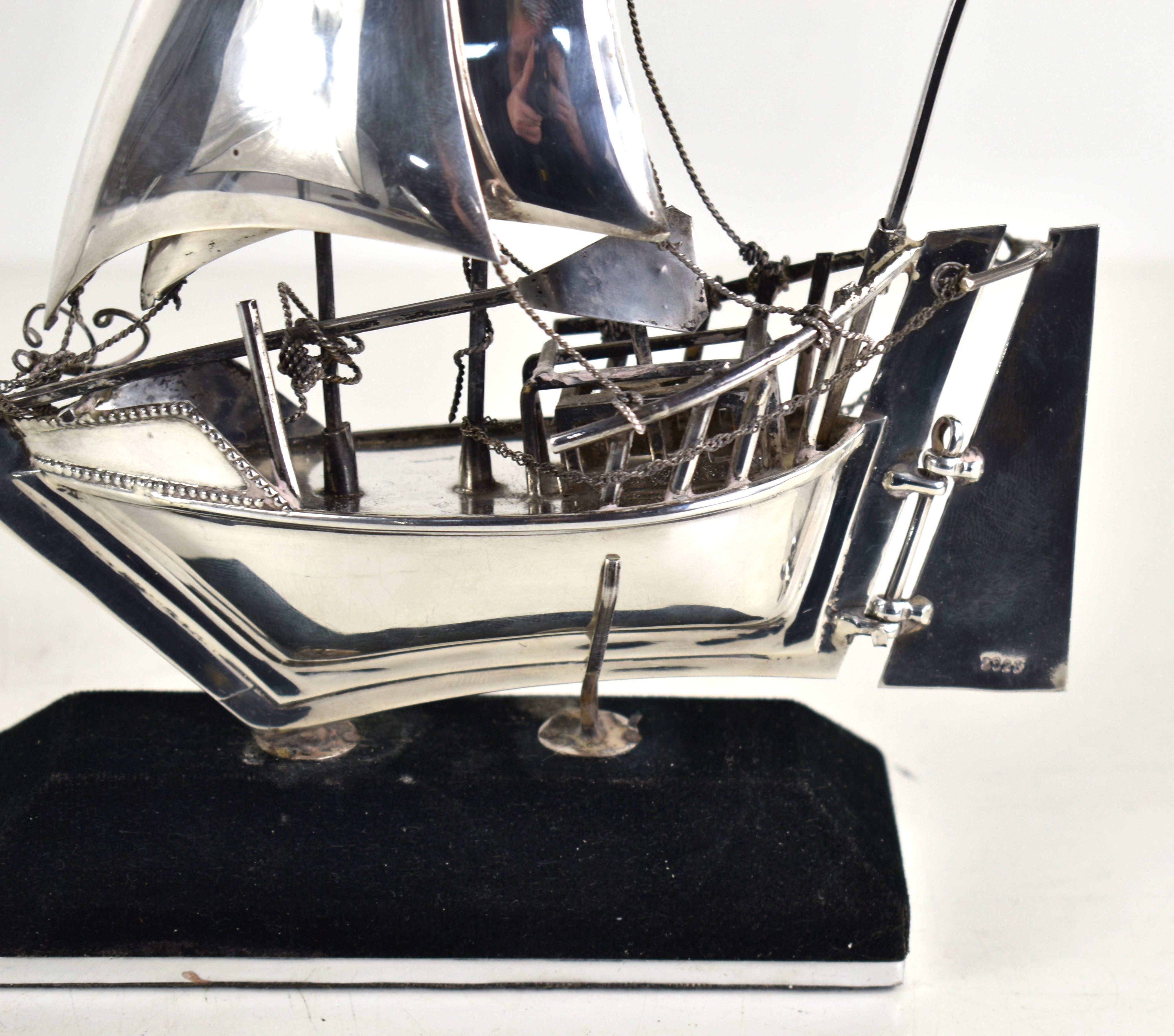 Sterling | A sterling silver model of a sailing boat on a stand | MutualArt