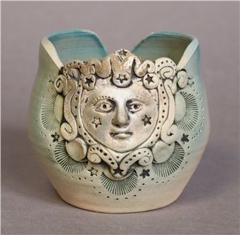 a ceramic small vase with relief mask to one side - Maria Papadimitriou