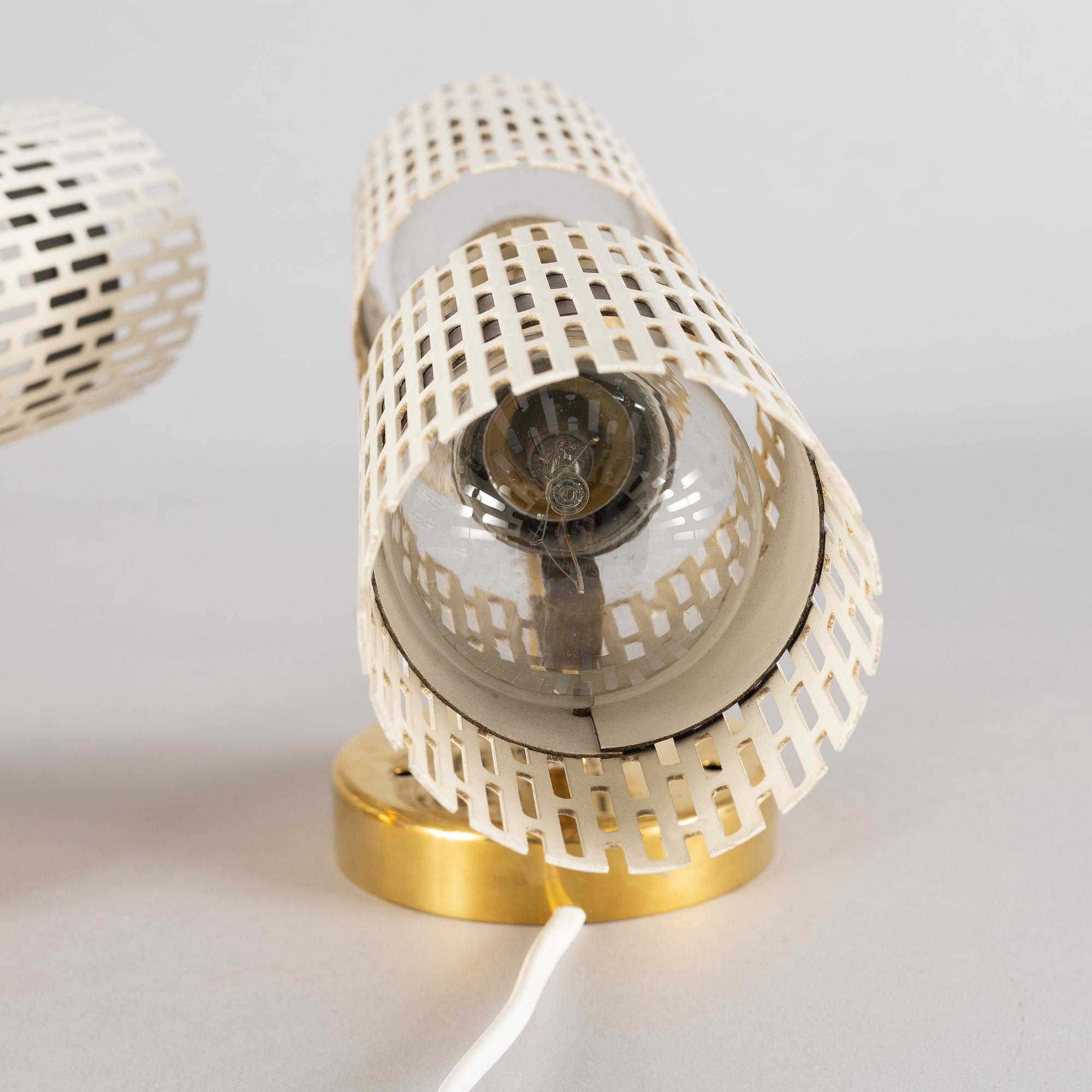 Artwork by Harald Notini, a pair of wall lamps model "8820", Arvid Böhlmarks Lampfabrik, Stockholm, 1940s-50s, Made of glass, wood and leather