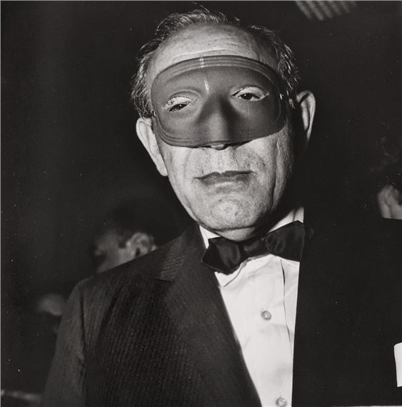 MASKED MAN AT A BALL by Diane Arbus, March 14