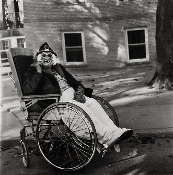 MASKED WOMAN IN A WHEELCHAIR by Diane Arbus, March 14