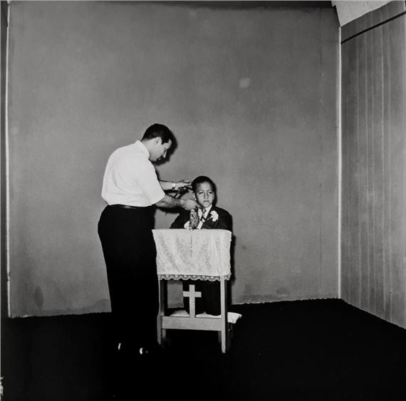 PHOTOGRAPHER POSING COMMUNION BOY