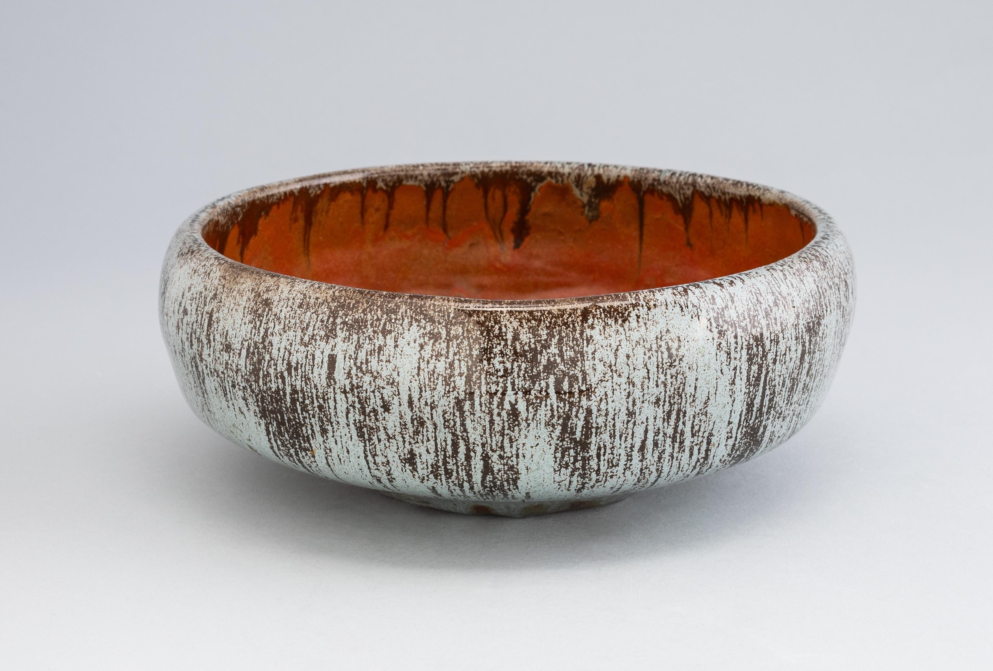 Margaret Grute | a blue and black glazed ceramic bowl, signed to the ...