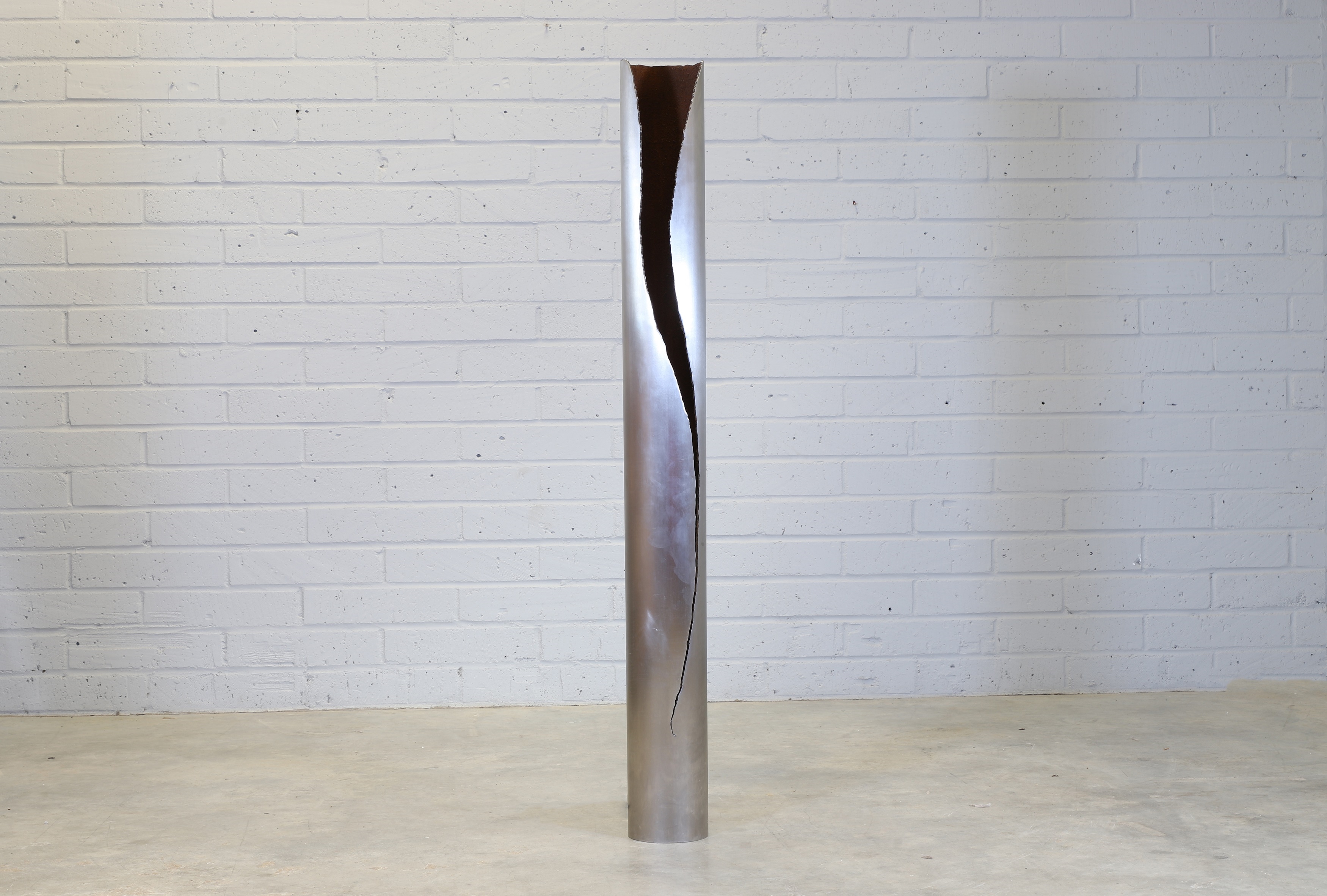 Artwork by Gianluca Pacchioni, Cut I designed in 2013 a tubular iron floor lamp to the side with an organically shaped cut, Made of tubular iron
