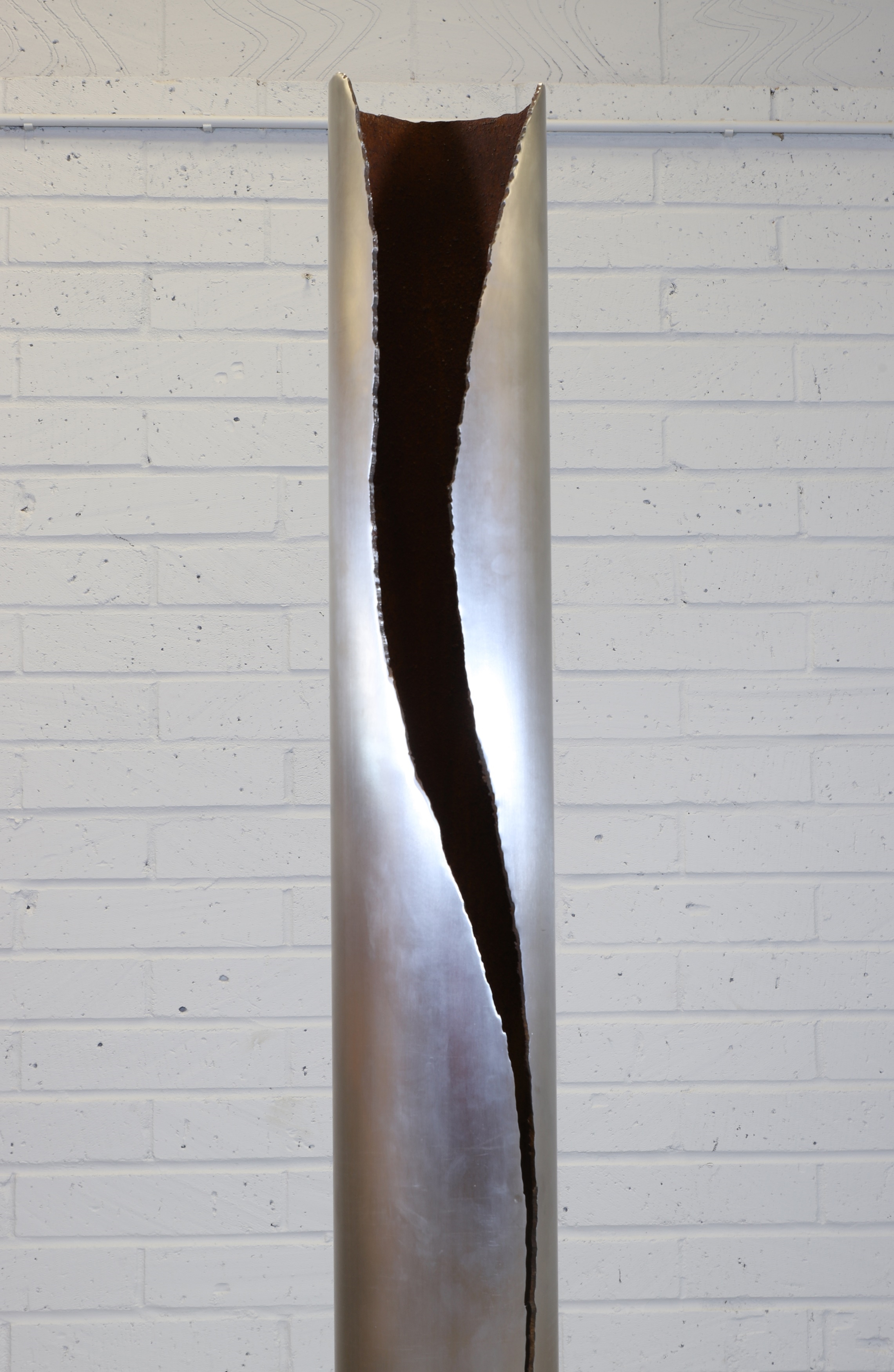 Artwork by Gianluca Pacchioni, Cut I designed in 2013 a tubular iron floor lamp to the side with an organically shaped cut, Made of tubular iron