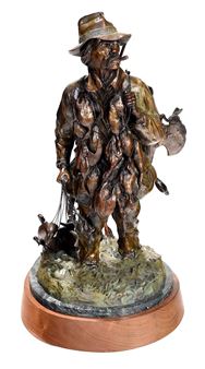 Duck hunter wading in with catch and decoys - Michael Ringer