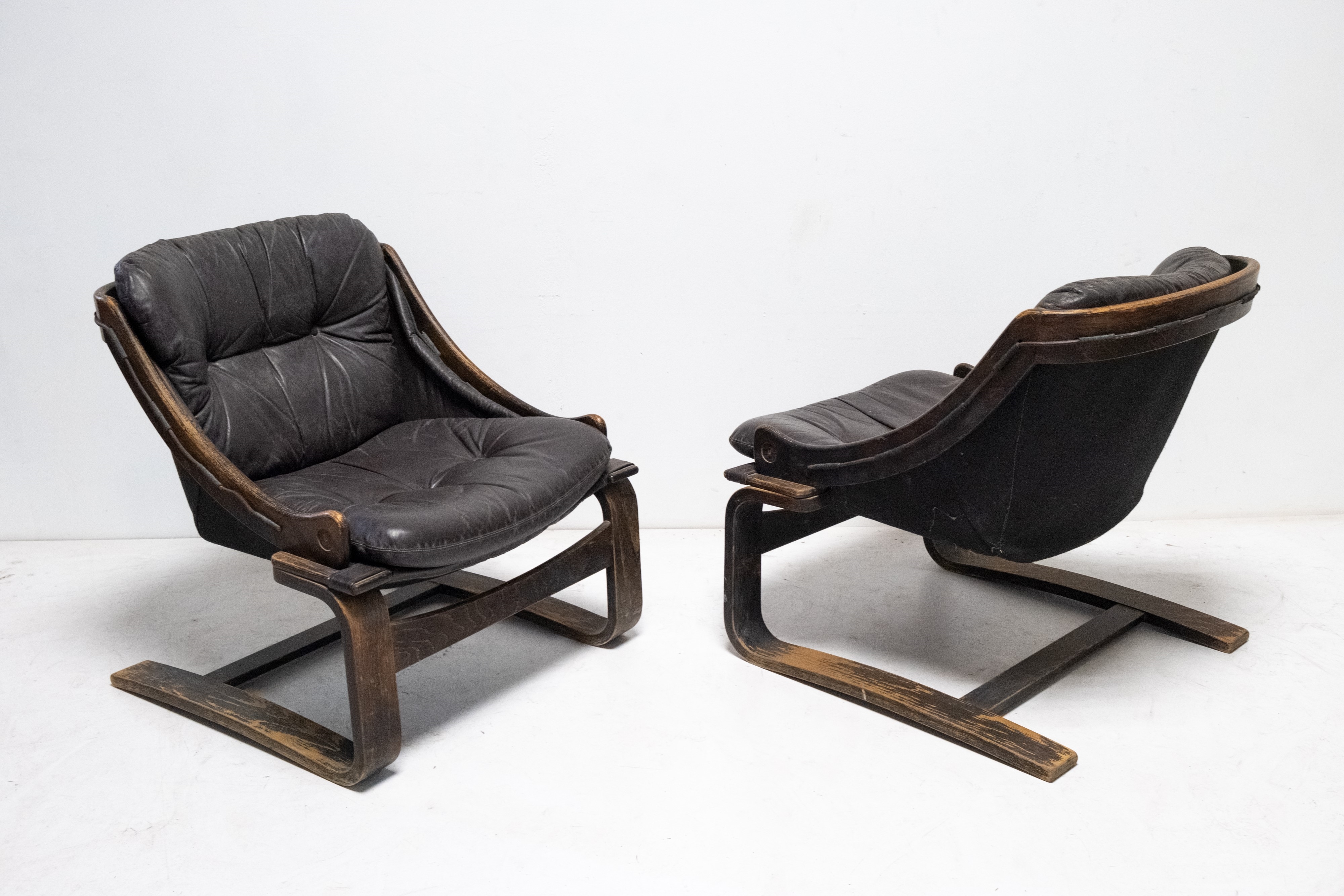 Artwork by Ake Fribyter, Pair of Krona lounge chairs, Made of wooden frame and leather upholstery