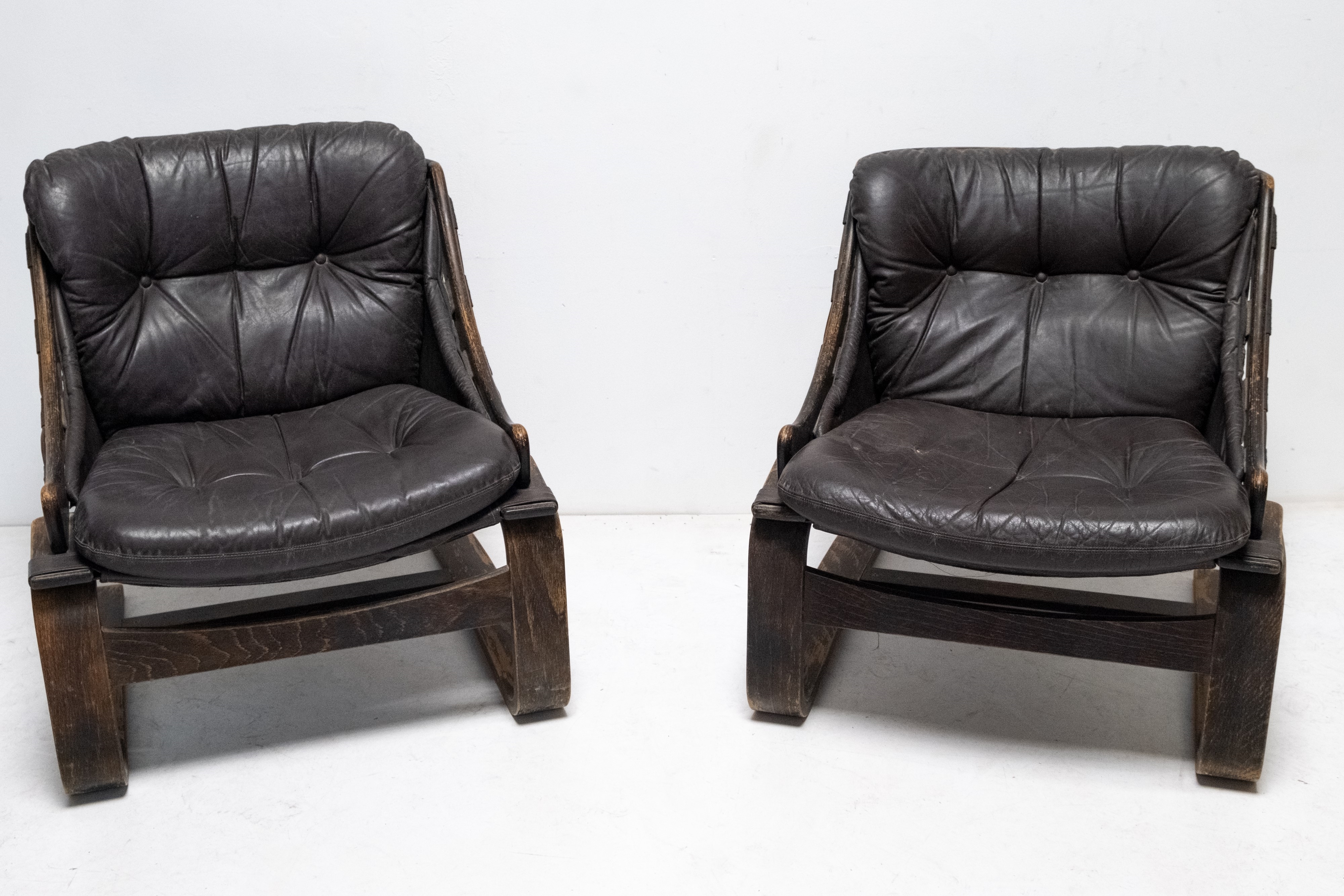 Artwork by Ake Fribyter, Pair of Krona lounge chairs, Made of wooden frame and leather upholstery