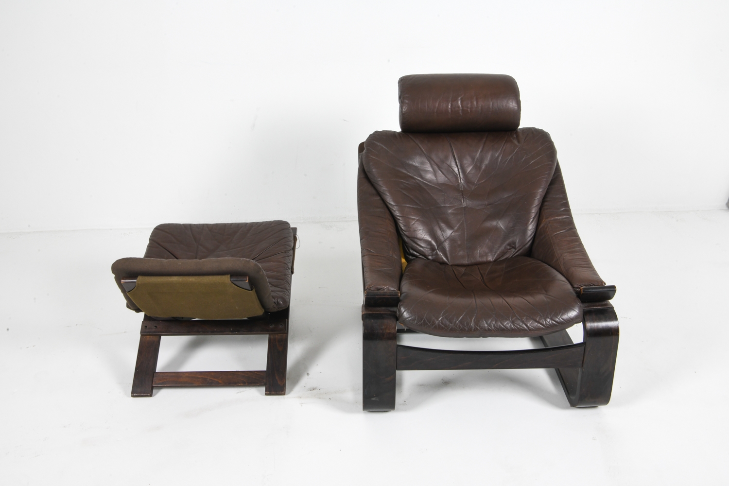 Artwork by Ake Fribyter, PAIR OF AKE FRIBYTTER LEATHER CHAIRS W/ OTTOMAN, Made of bentwood frames with leather upholstery
