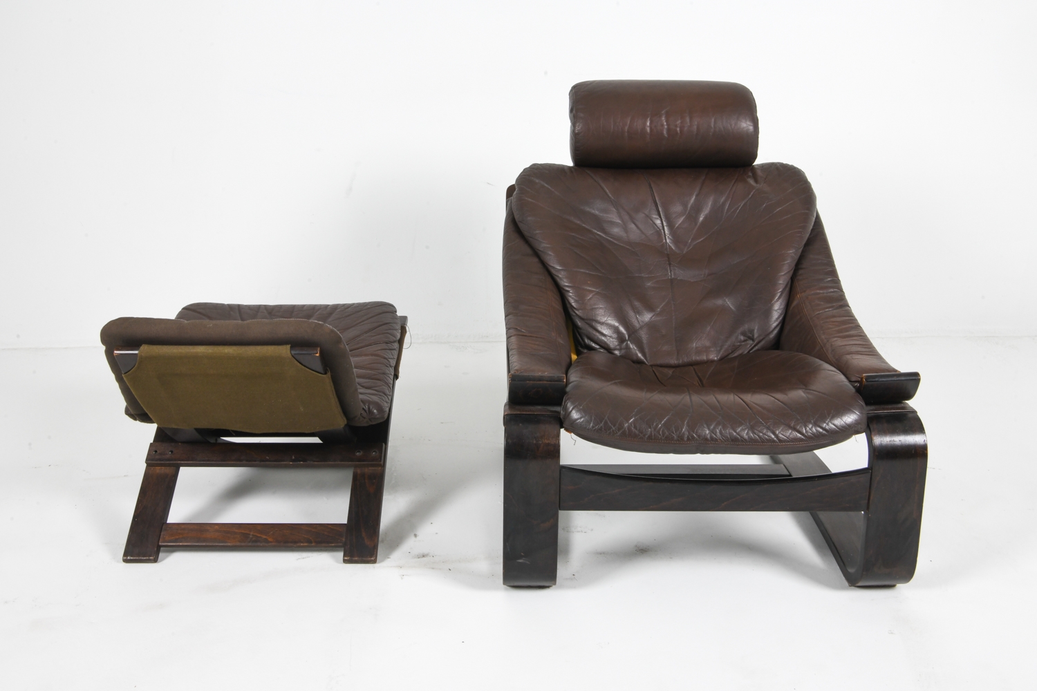 Artwork by Ake Fribyter, PAIR OF AKE FRIBYTTER LEATHER CHAIRS W/ OTTOMAN, Made of bentwood frames with leather upholstery