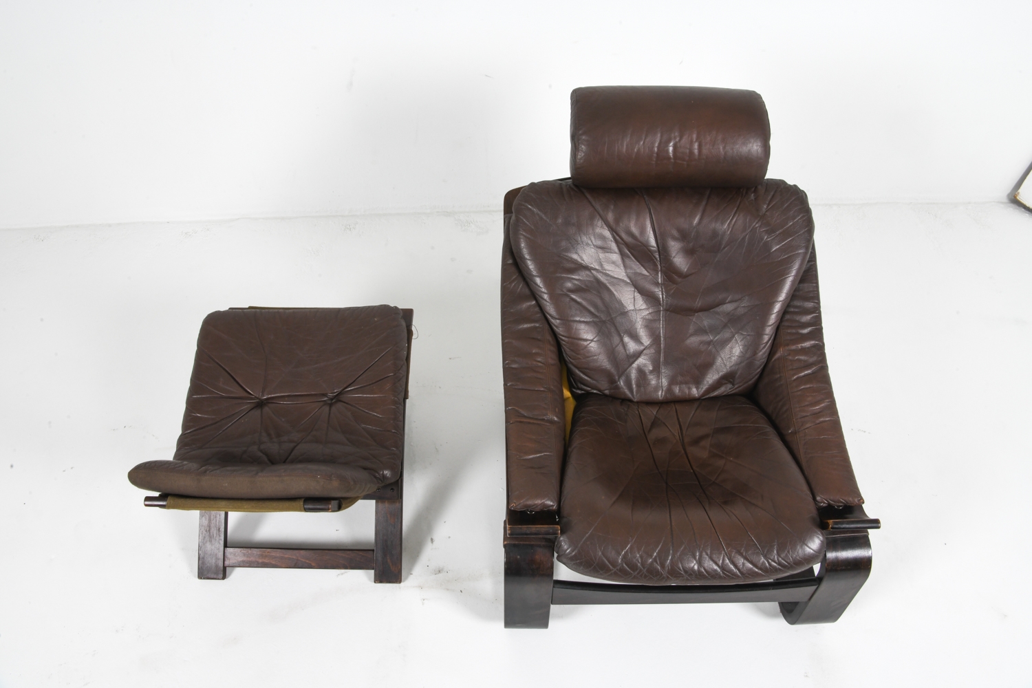 Artwork by Ake Fribyter, PAIR OF AKE FRIBYTTER LEATHER CHAIRS W/ OTTOMAN, Made of bentwood frames with leather upholstery
