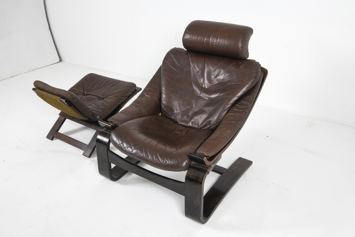 Artwork by Ake Fribyter, PAIR OF AKE FRIBYTTER LEATHER CHAIRS W/ OTTOMAN, Made of bentwood frames with leather upholstery