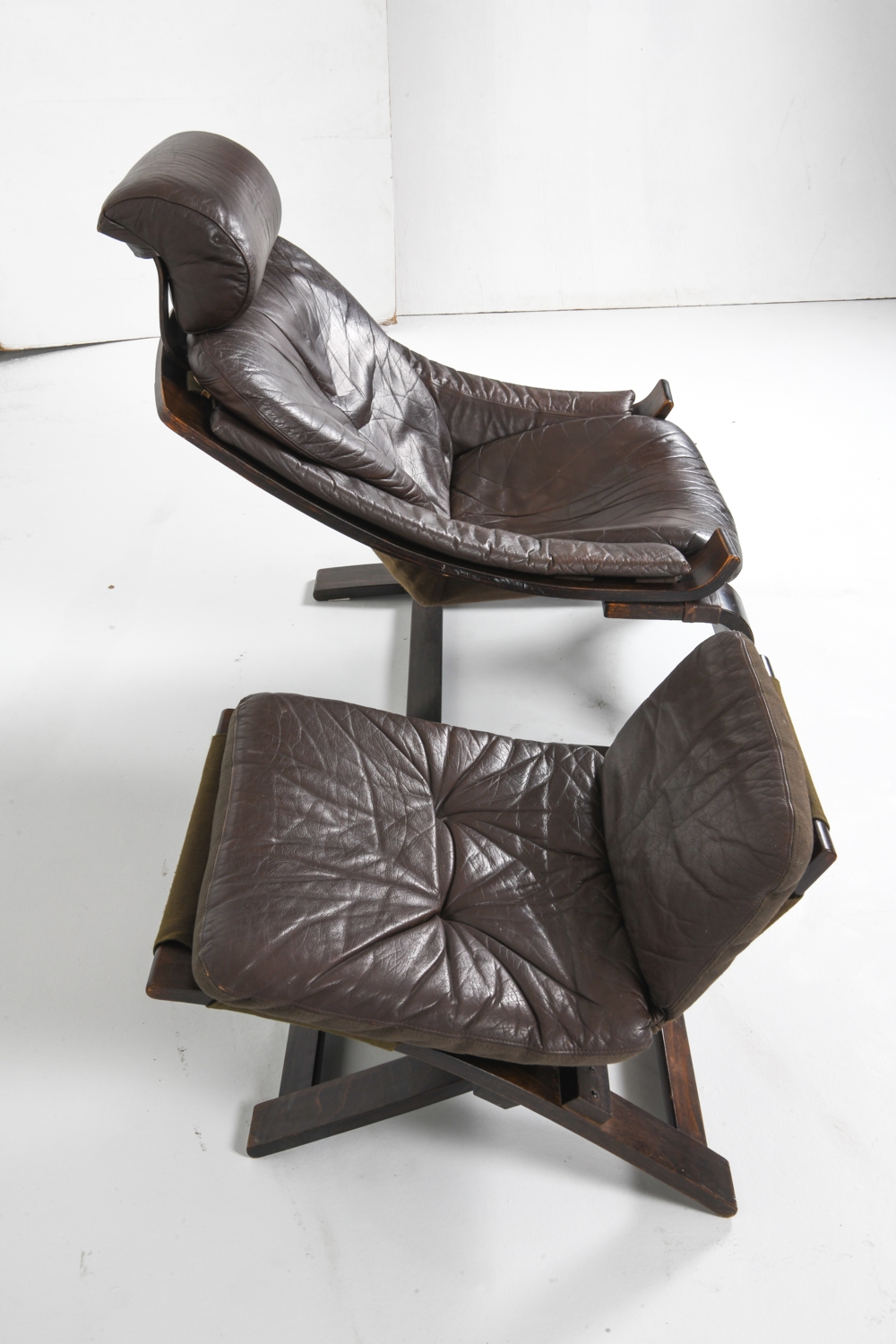 Artwork by Ake Fribyter, PAIR OF AKE FRIBYTTER LEATHER CHAIRS W/ OTTOMAN, Made of bentwood frames with leather upholstery