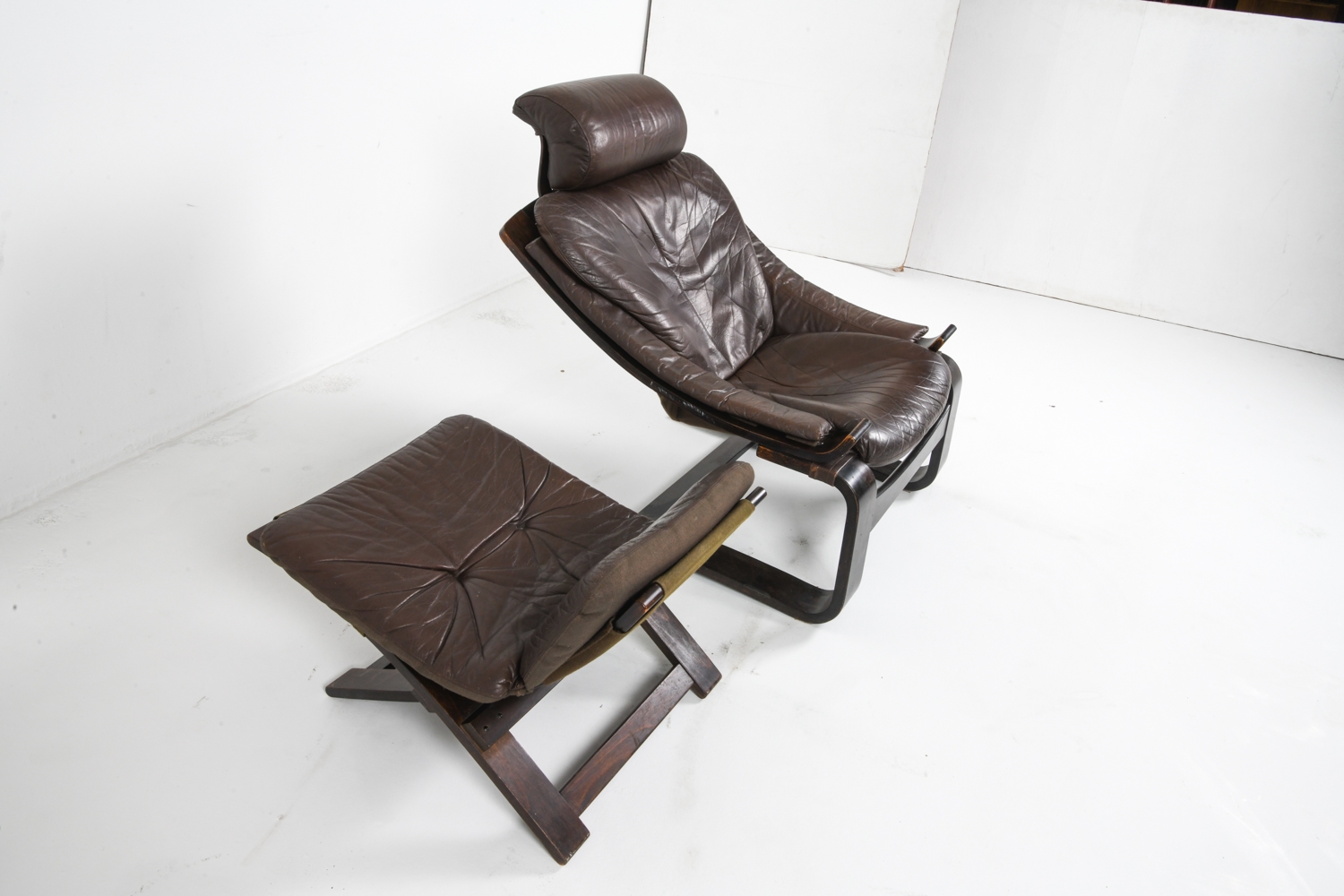 Artwork by Ake Fribyter, PAIR OF AKE FRIBYTTER LEATHER CHAIRS W/ OTTOMAN, Made of bentwood frames with leather upholstery