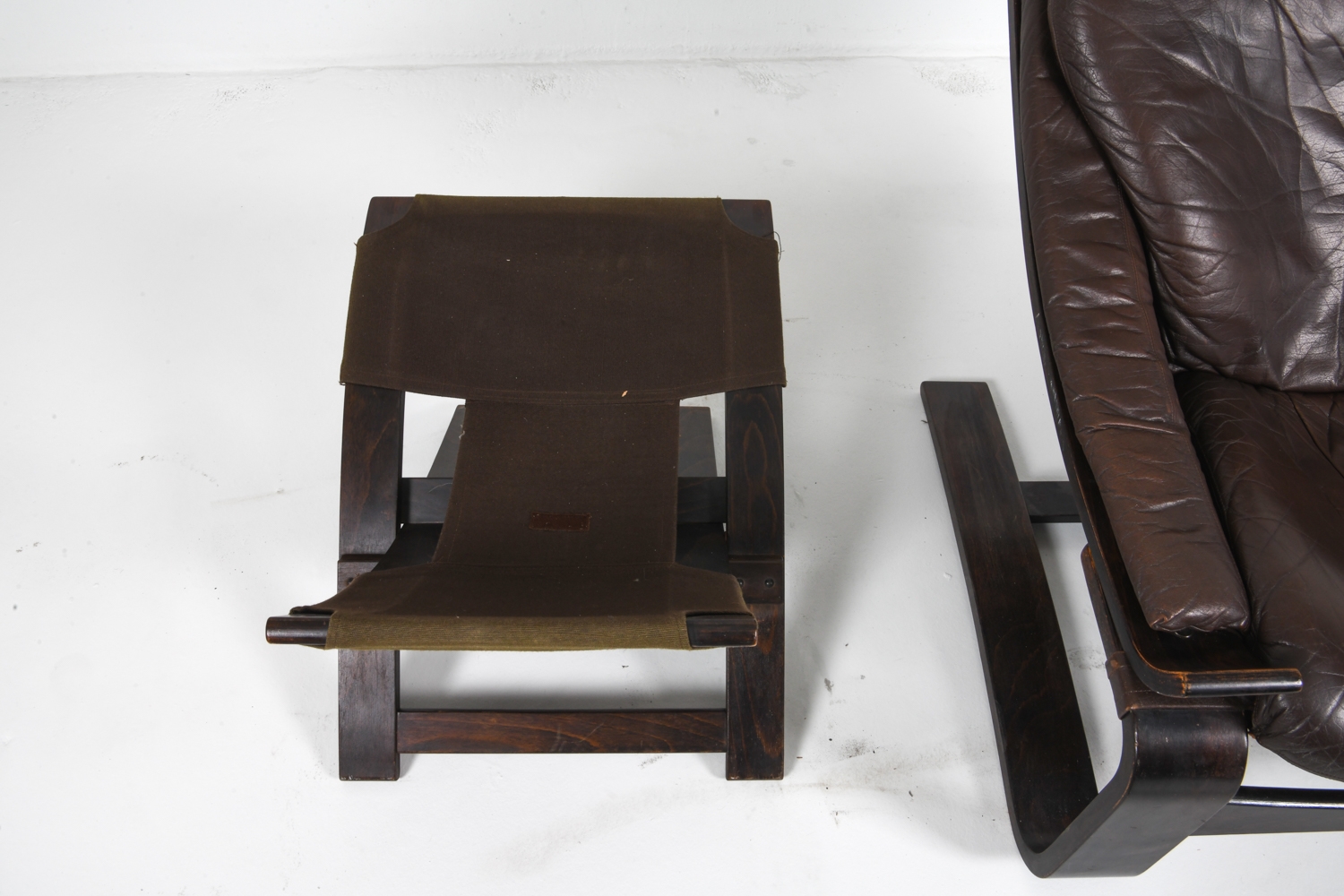 Artwork by Ake Fribyter, PAIR OF AKE FRIBYTTER LEATHER CHAIRS W/ OTTOMAN, Made of bentwood frames with leather upholstery