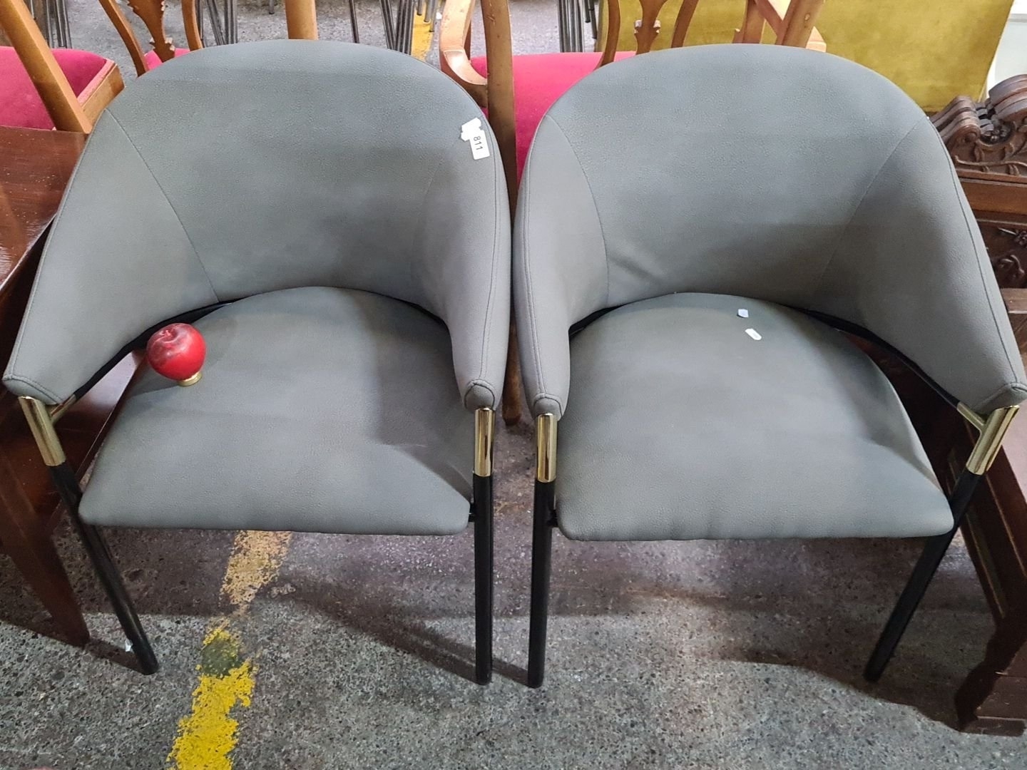 Artwork by Kare Design, Star Lot A super Pair of as new Kare Design with curved backs, upholstered in soft grey leather with sleek black metal legs and brass-tone accents, Made of Brass