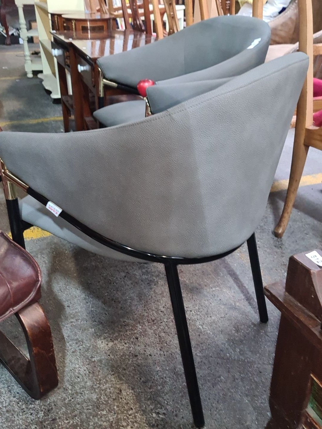 Artwork by Kare Design, Star Lot A super Pair of as new Kare Design with curved backs, upholstered in soft grey leather with sleek black metal legs and brass-tone accents, Made of Brass