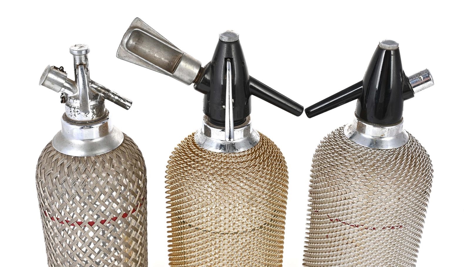 Silver | Collection of three soda syphons with silver tone mesh covers ...