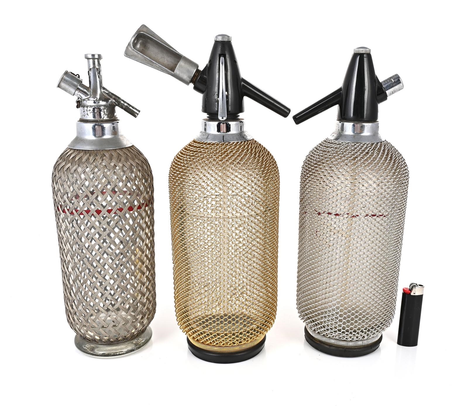 Silver | Collection of three soda syphons with silver tone mesh covers ...